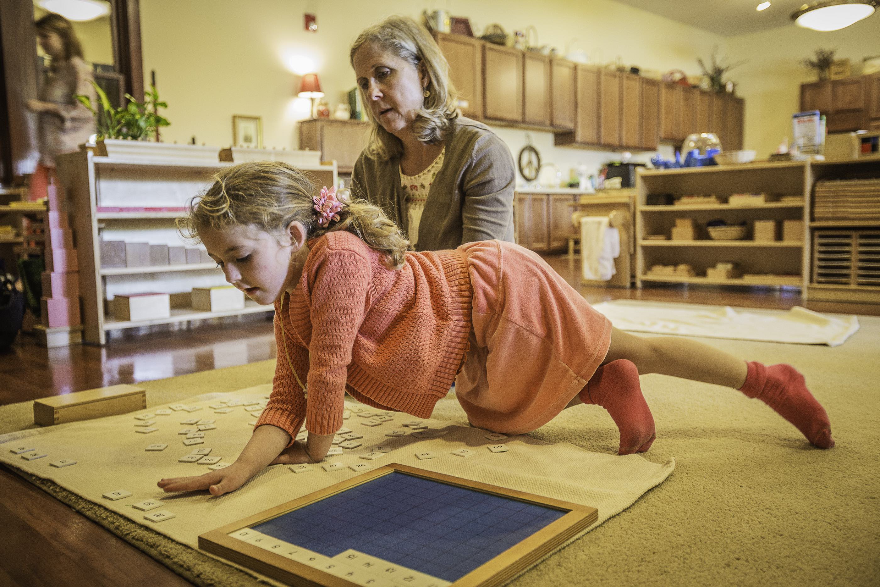 Teacher and Child playing with letters