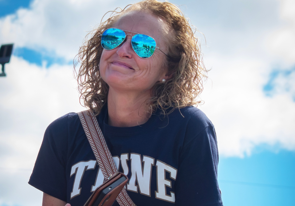 woman in a trine shirt smiling