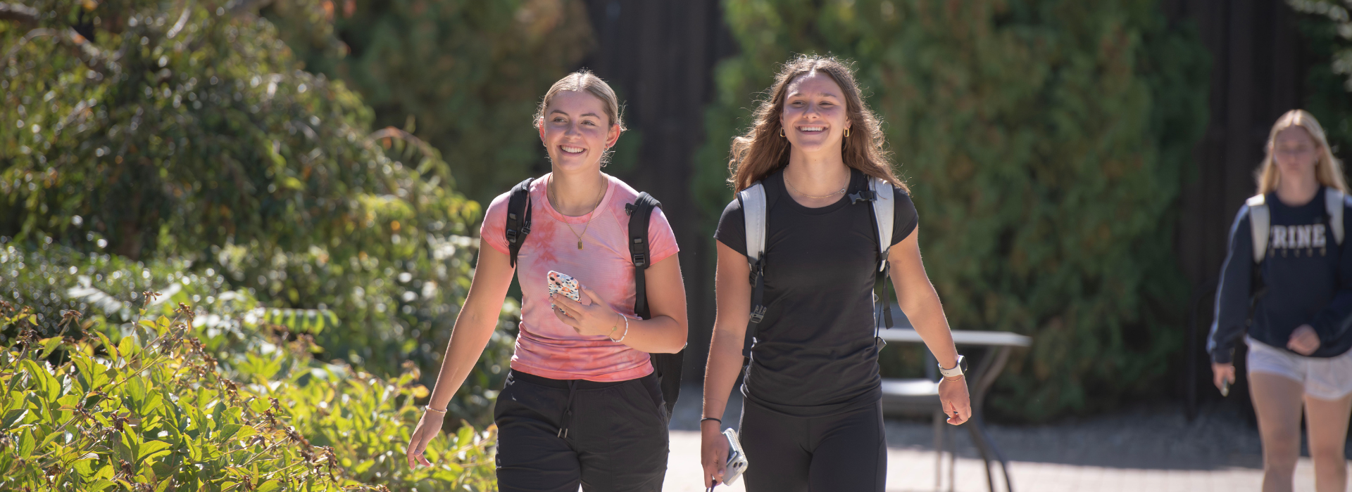 two student smiling outside on trine's campus
