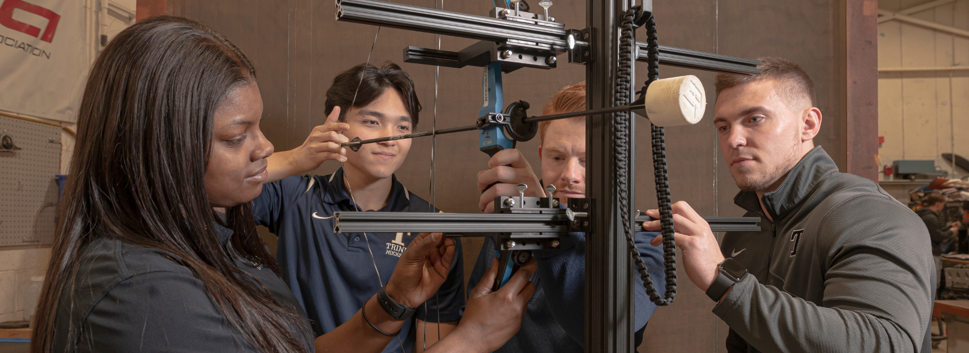 engineering students work on an adaptive archery stand