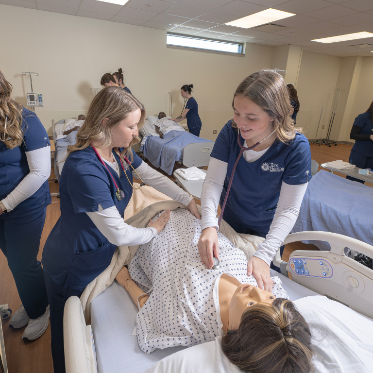 two nursing students practicing