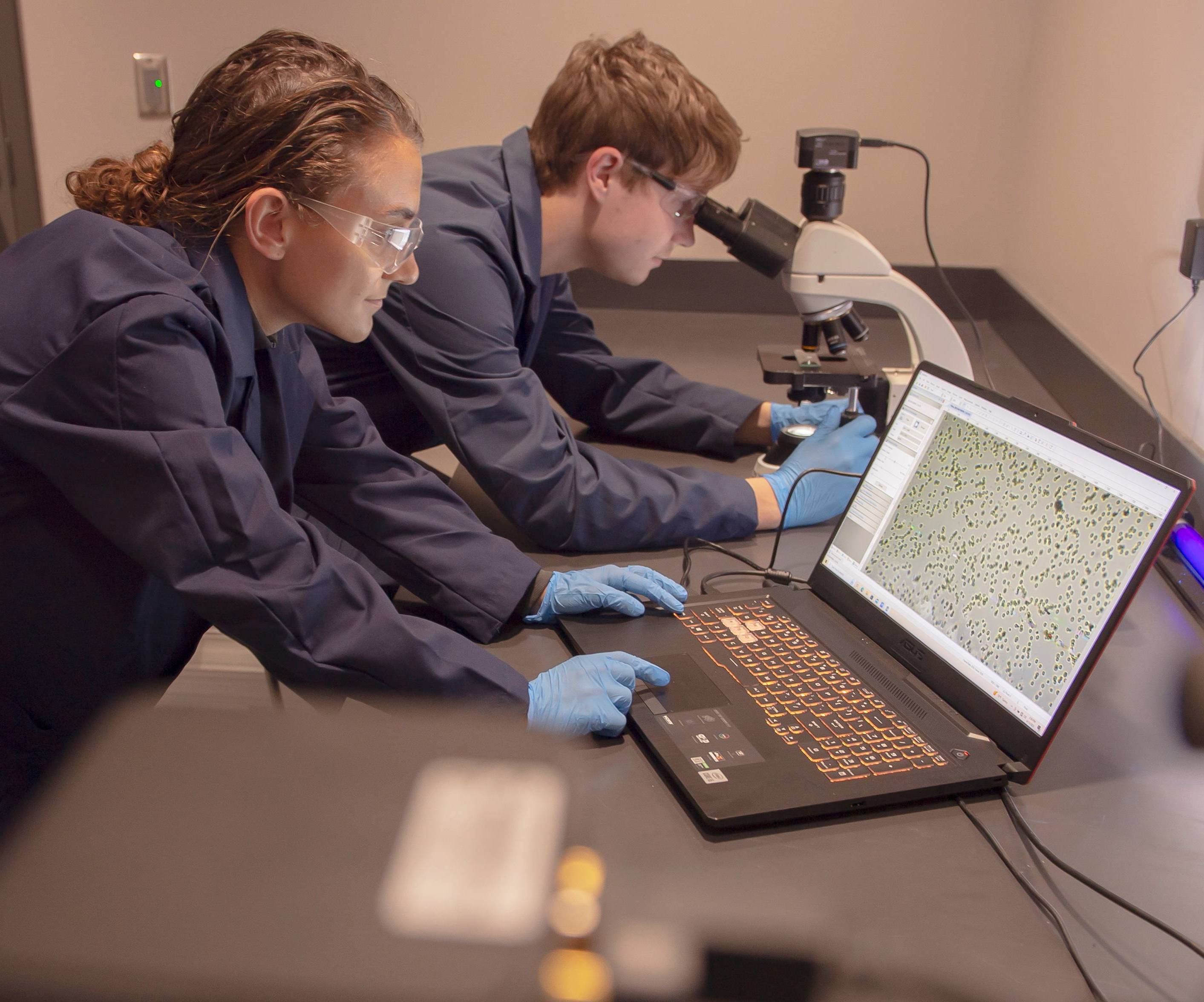 Students looking through microscope