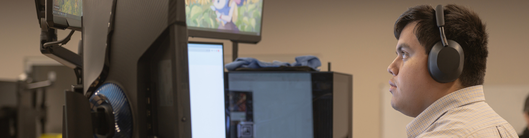 student looking at multiple computer monitors
