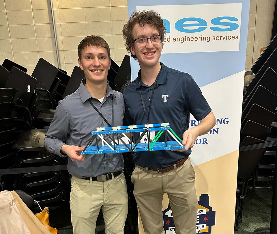 Civil engineering students with 3D-printed bridge