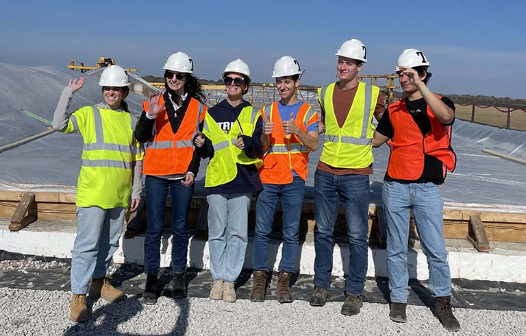 Trine University civil engineering students standing near bridge construction