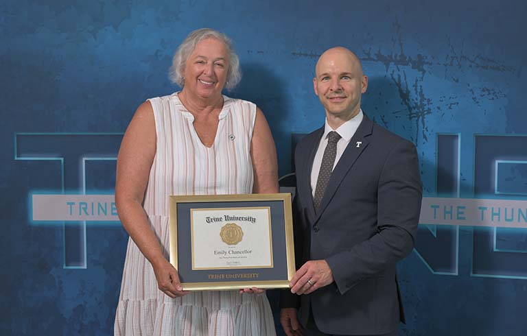 Emily Chancellor receives an award for 35 years of service to Trine University from Dr. Tony Kline