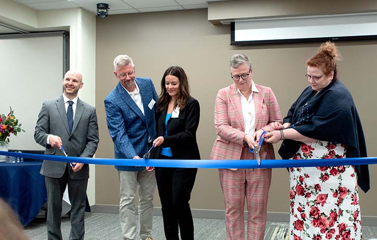 Trine and Cameron officials and Gutstein family cutting ribbon 