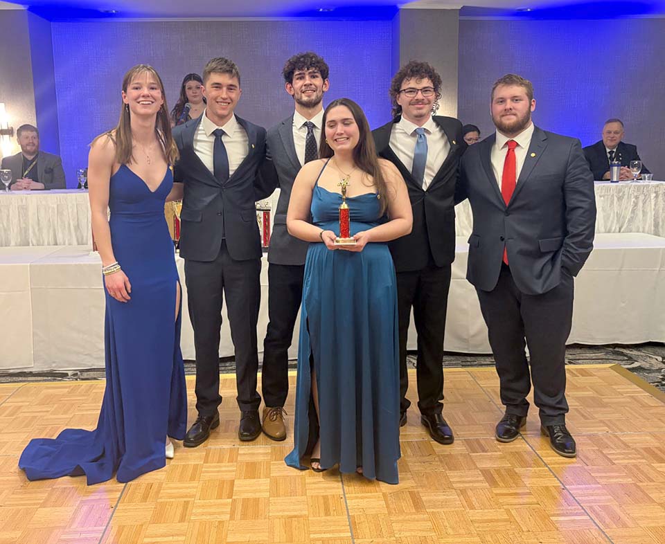 Six students with trophy