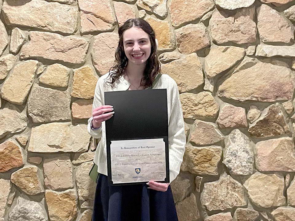 Annalise O'Daniel holding award