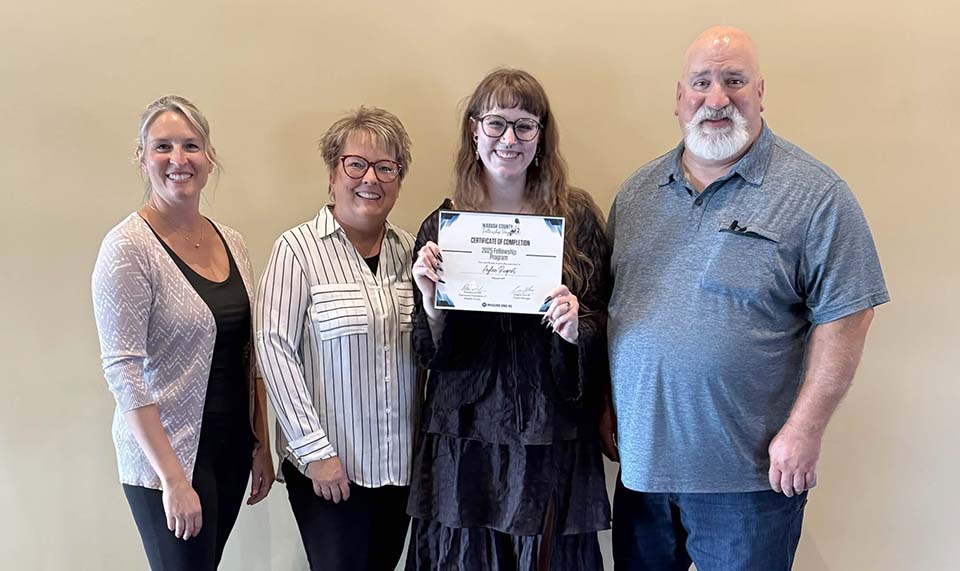 Aylee Rupert with certificate and three officials
