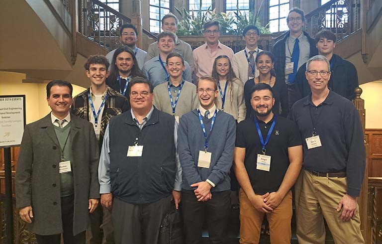 Students and faculty standing on stairs
