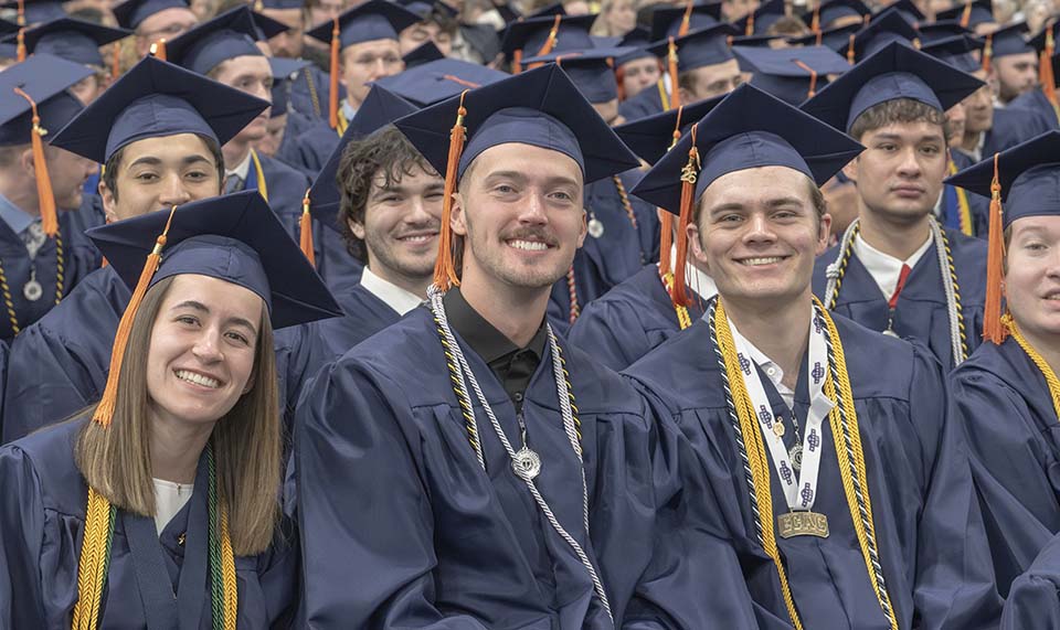 Smiling students in caps and gowns