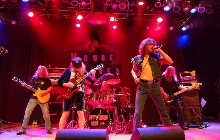 AC/DC tribute band Dirty Deeds on stage at House of Blues with lights and fog.