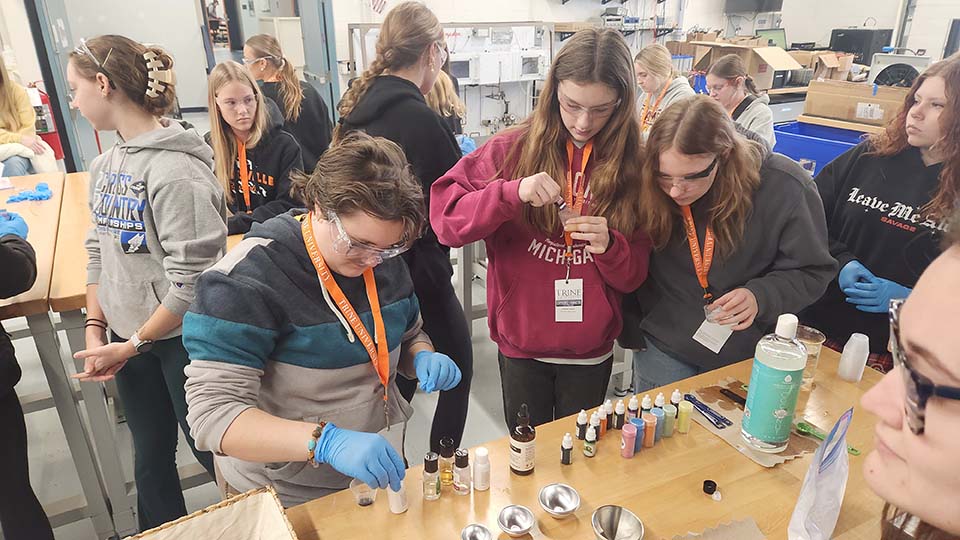 High school students working with lab equipment