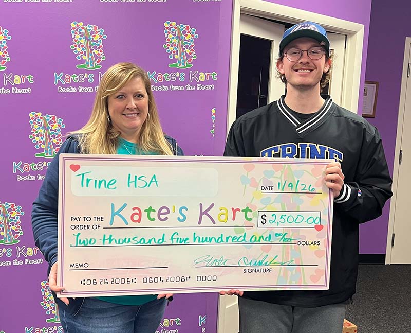 Jennifer Nixon and Hunter Overholser with large check for $2,500