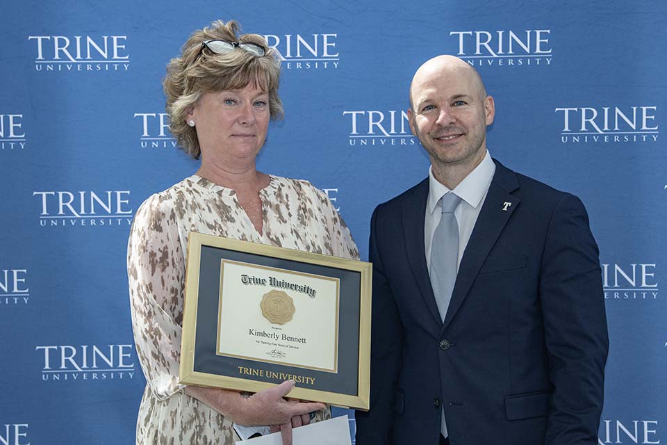 Kim Bennett with framed certificate standing next to Dr. Tony Kline