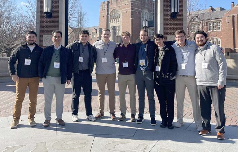 Professor and eight students on the Purdue University campus