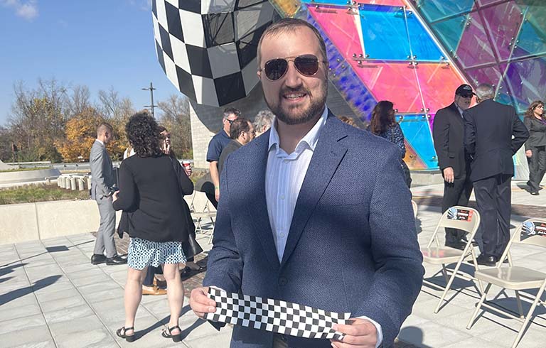 Russel Reynolds holding checkered ribbon