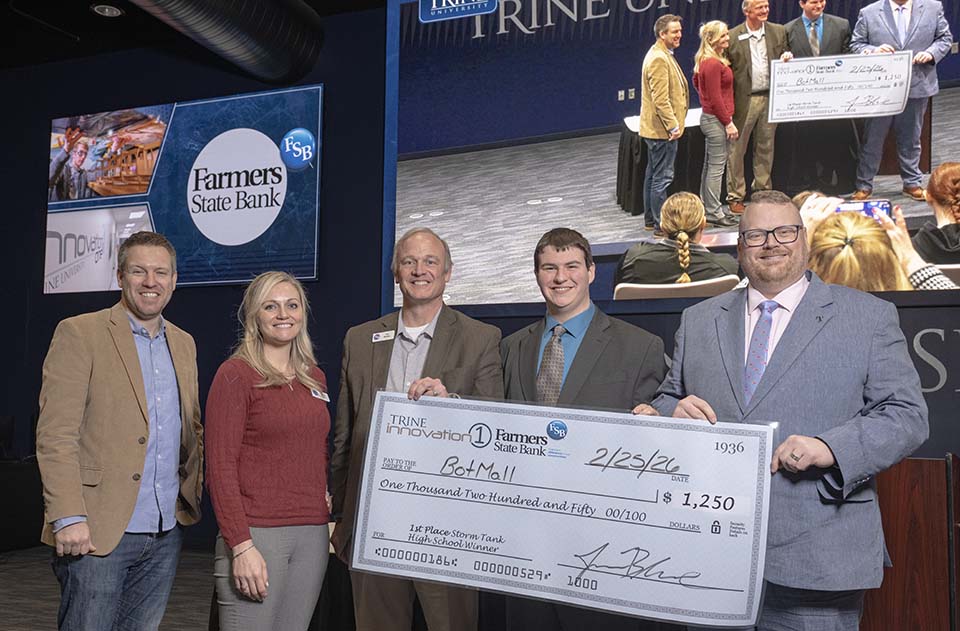 Three Farmers State Bank executives, high school student and Jason Blume with large check