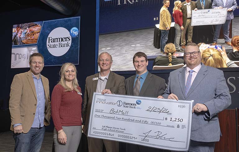 Three executives from Farmers State Bank, high school student and Jason Blume with large check.
