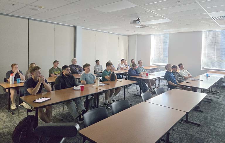 Students seated at desks looking off-camera
