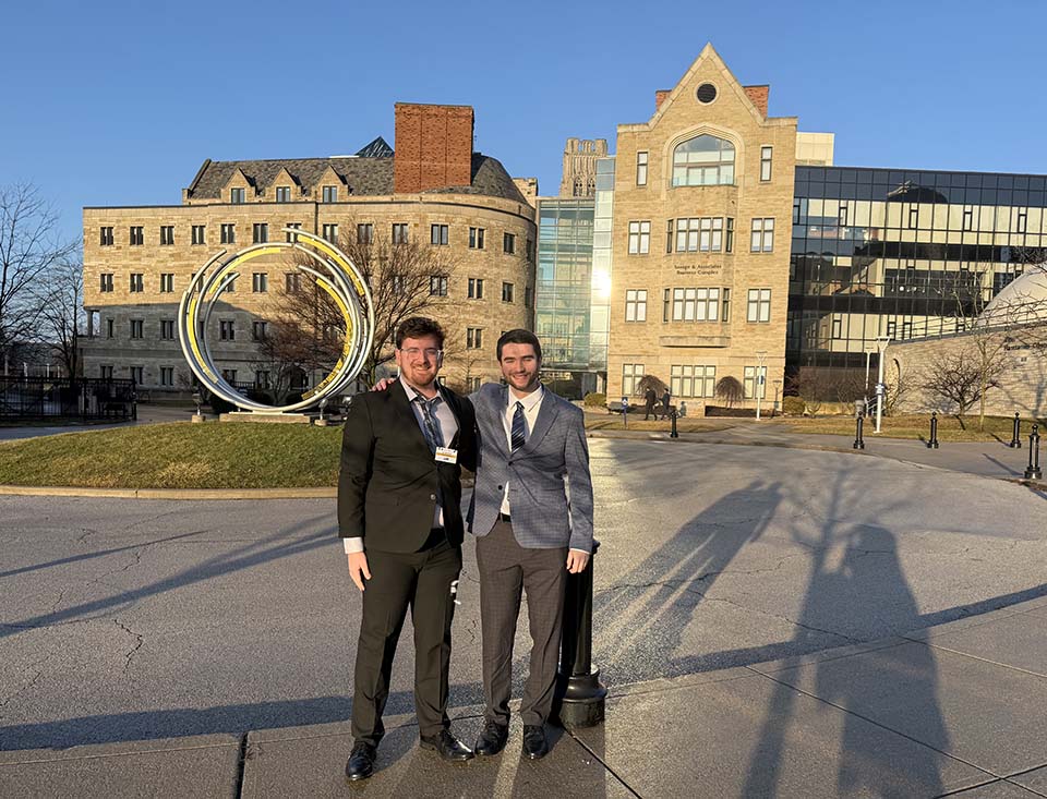 Jacob Seier and Carson Sickmiller in front of University of Toledo buildings