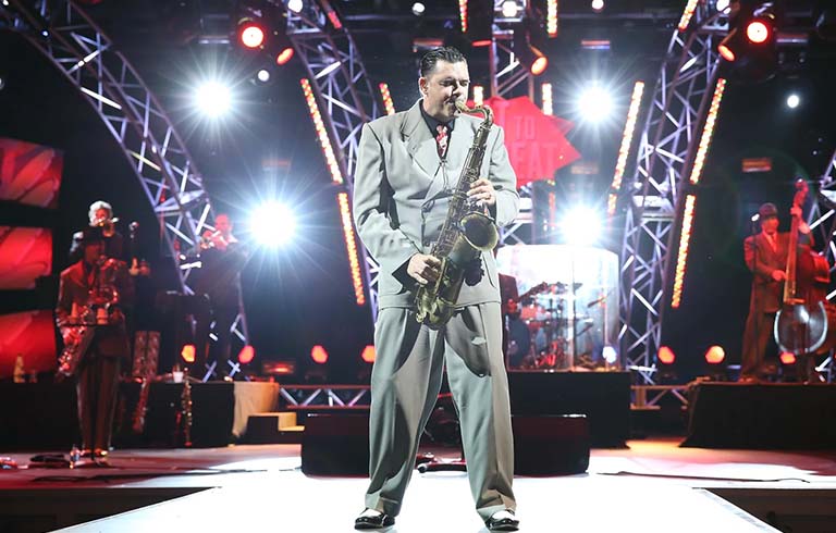 Band playing with saxophone soloist front and center.